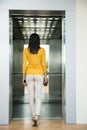 Back view portrait of a woman going in elevator Royalty Free Stock Photo