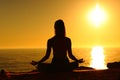 Yogi silhouette on the beach doing yoga