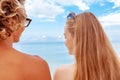 Back view portrait of young couple in love enjoying time being together at sandy beach. Royalty Free Stock Photo