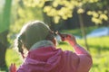 Back view of preschooler girl holding edible snail