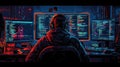 Back view of a programmer wearing headphones working on a computer in a dark room Royalty Free Stock Photo