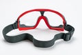 Back view of red and gray frame of multipurpose goggles with black elastic strap on white background Royalty Free Stock Photo