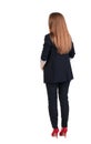 Back view of redhead business woman contemplating.