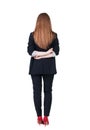 Back view of redhead business woman contemplating.