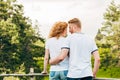 back view of redhead couple embracing and smiling each other while standing together Royalty Free Stock Photo