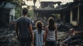 back view of refugee family looking at destroyed home after war, desperate people near demolished house after natural Royalty Free Stock Photo