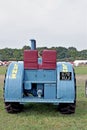 Back view of a retro light blue tractor with two seats