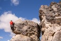 Back view of rock climber reaching the top of a limestone route. Royalty Free Stock Photo