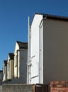 Back view of a row of white and yellow painted typical small english terraced housed in fleetwood lancashire Royalty Free Stock Photo