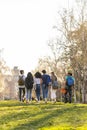 Back view of a row of young multi-ethnic students walking together in the park Royalty Free Stock Photo