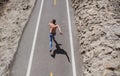 Back view of runner man running jogging on road. Fit male madel workout with bare torso on urban street.