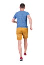 Back view of running man in t-shirt and shorts Royalty Free Stock Photo