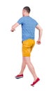 Back view of running man in t-shirt and shorts Royalty Free Stock Photo