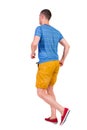 Back view of running man in t-shirt and shorts Royalty Free Stock Photo