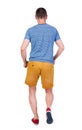 Back view of running man in t-shirt and shorts Royalty Free Stock Photo