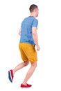 Back view of running man in t-shirt and shorts Royalty Free Stock Photo