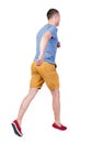 Back view of running man in t-shirt and shorts Royalty Free Stock Photo