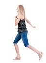 Back view of running woman. beautiful blonde girl in motion.