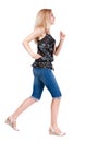 Back view of running woman. beautiful blonde girl in motion.