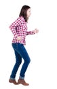 Back view of running woman in checkered shirt Royalty Free Stock Photo