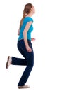 Back view of running woman in jeans Royalty Free Stock Photo