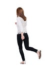 Back view of running woman in jeans Royalty Free Stock Photo