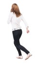 Back view of running woman in jeans Royalty Free Stock Photo