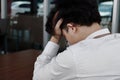 Back view of sad depressed young Asian business man covering face and cry. Royalty Free Stock Photo