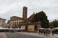 Back view of San Giovanni Church and Sunday market on Piazza San Martino. Lucca. Italy. Royalty Free Stock Photo