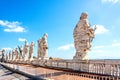 Back view of the sculptures of the twelve saints at the top of St. Peter`s basilica in Vatican.