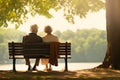 Back view of senior couple sitting on bench in the park