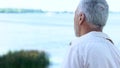 Back view of senior man looking at river and beautiful landscape, tourism