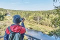 Senior man shooting movie about nature on video camera. Royalty Free Stock Photo