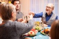 Back view of senior woman clinking a glass of wine