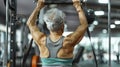 The Back View of a Senior Woman Committed to Staying Healthy through Gym Exercises Royalty Free Stock Photo