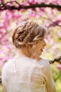 Back view of sensual young woman standing in blooming garden Royalty Free Stock Photo