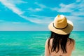 Back view of and happy young Asian woman wear straw hat relaxing and enjoy holiday at tropical paradise beach. Girl standing Royalty Free Stock Photo