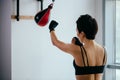 Back view shot of slim woman with short hair training for boxing championat