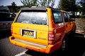 Back view shot of a yellow Great Wall safe car parking on the street in China