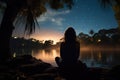 Back view silhouette of a girl sitting near a lagoon at night