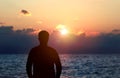 Back view silhouette photo of depressed man watching the sunset. Royalty Free Stock Photo