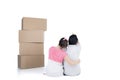 Back view of sitting cute couple with stack of cardboard boxes Royalty Free Stock Photo