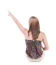 Back view of sitting pointing woman. beautiful blonde girl. Royalty Free Stock Photo