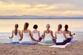 Back view women sitting in lotus pose meditating outdoors Royalty Free Stock Photo