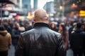 Back view of skinhead neo-nazi with shaved heads and leather jacket in street