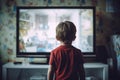 Back view of small child watching TV