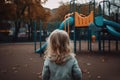 back view of small girl child at empty playground