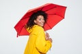 Back view of smiling woman in raincoat hiding under umbrella Royalty Free Stock Photo