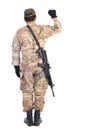 Back view of a soldier with gun holding his arm up Royalty Free Stock Photo