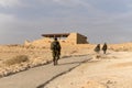 Back view of soldiers of infantry army moving in desert. Sand and sky on background of military israel men in fortress. Tired